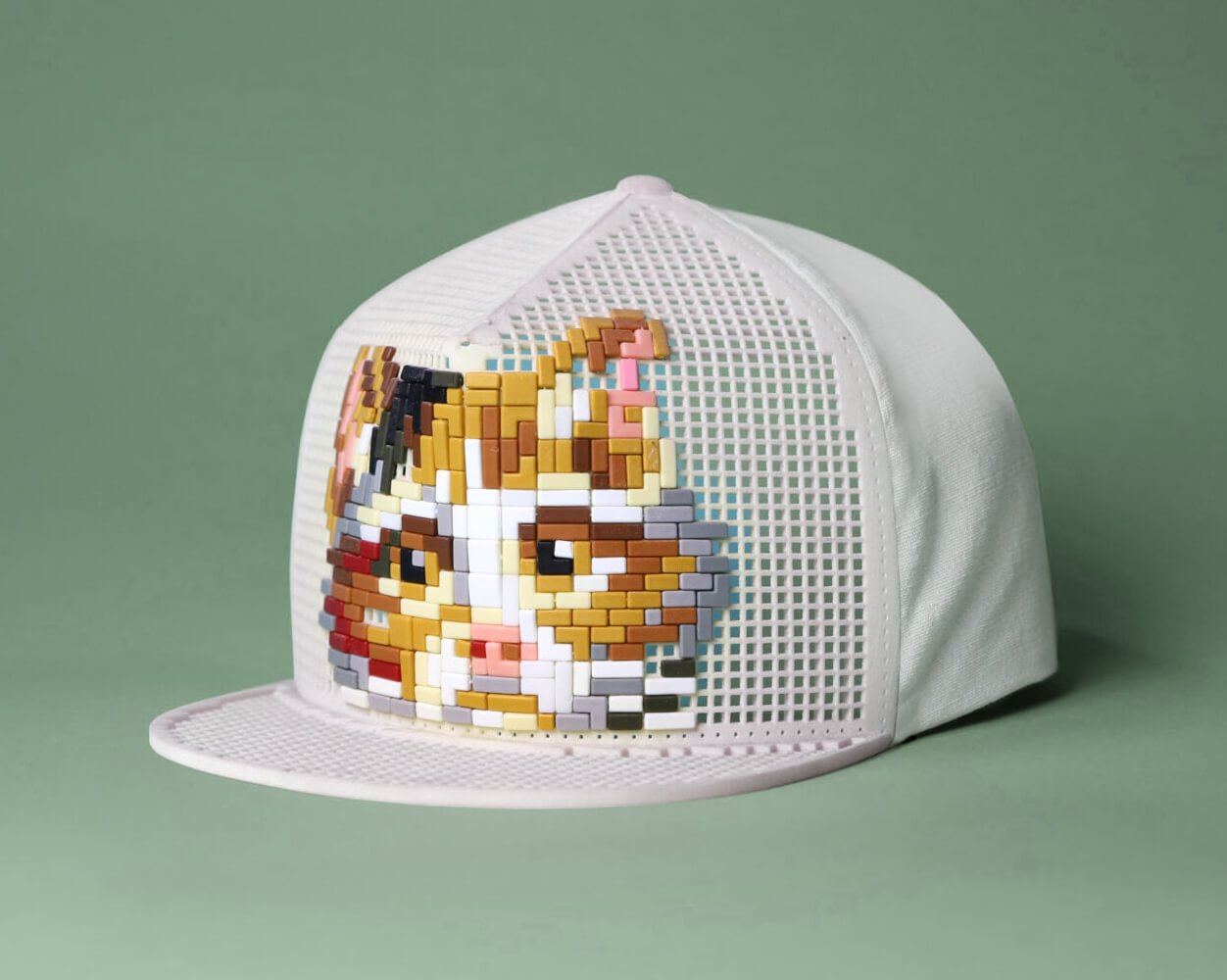 Stick 'm In with Ministeck: white cap with a pixelated cat, by Jessica Kersten and Jord Beets