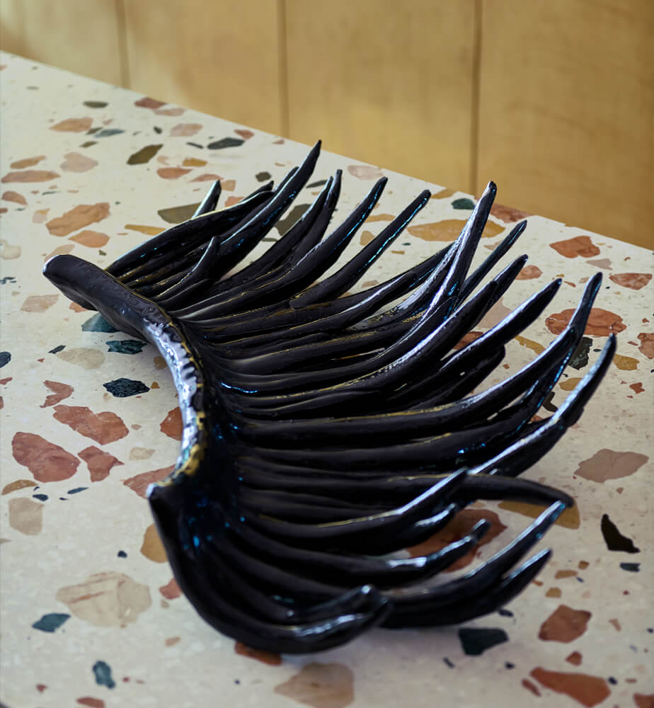 Eyelash, black glazed ceramic sculpture by Marlies Neugebauer