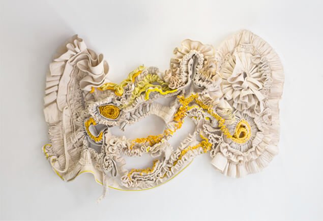 Ruffled white and yellow textile sculpture by Thera Hillenaar
