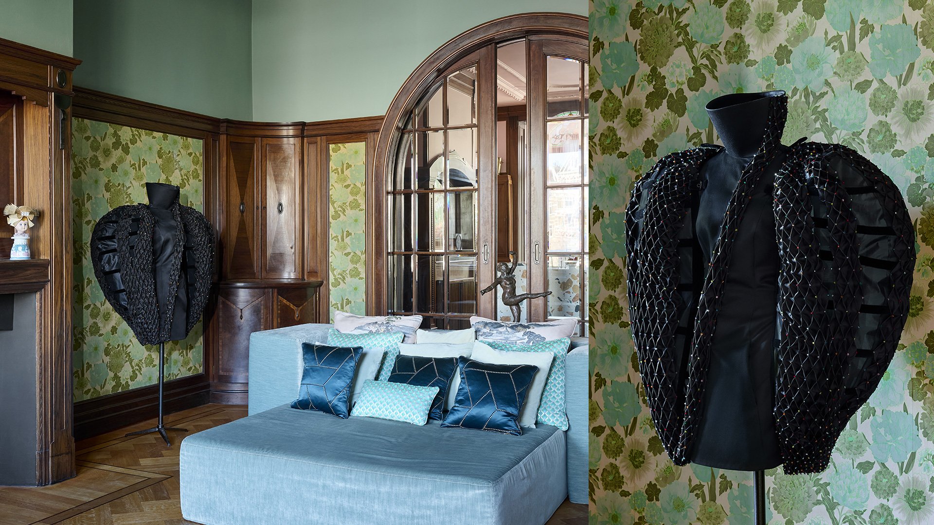 Black couture pieces by Ronald van der Kemp in a wood-panelled room with a blue sofa