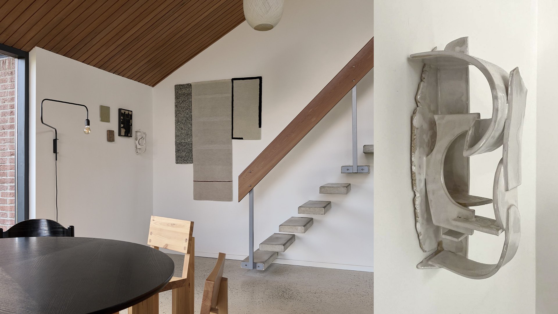 Loft with a floating staircase and a silver wall sculpture