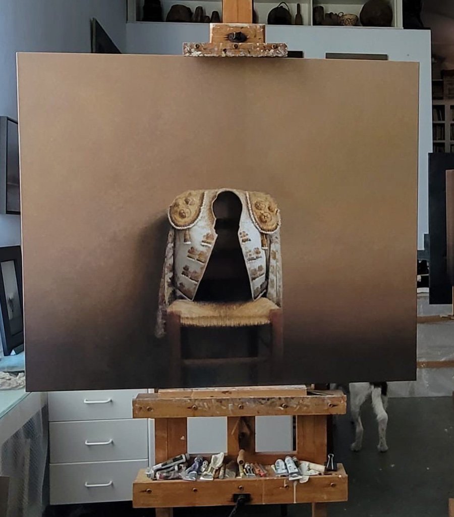 Painting of a matador jacket on a chair, on an easel in the studio